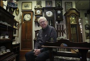 Ted Powers is surrounded by treasures from the past at Ancestor House Antiques, which he owns with his wife, Sheila.