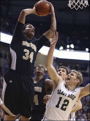 Wofford center Lee Skinner scores over Xavier guard Brad Redford (12) in the second half Saturday in Cincinnati.