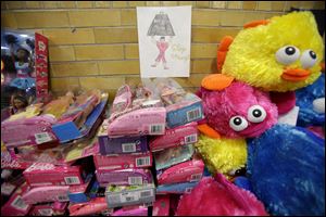 A message of support hangs over a table full of donated toys at the town hall in Newtown, Conn.