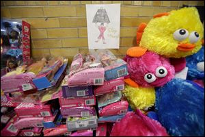 A message of support hangs over donated toys in Newtown, Conn. Officials are overwhelmed by the amount and struggle to distribute the gifts.