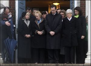 Connecticut Gov. Dannel Malloy, center, observes a moment of silence with other officials in Newtown, Conn. Statewide bell-ringing honored the dead.