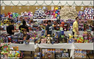 Volunteers look over tables full of donated toys at the town hall in Newtown, Conn.