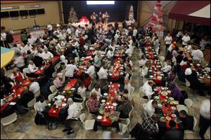 Dozens of residents of Cherry Street Mission and the Sparrow's Nest join members of Cedar Creek Church for a meal during a holiday celebration at the church's Perrysburg Township campus.