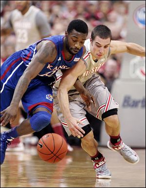 Deshaun Thomas, who led Ohio State with 16 points, drives against Kansas' Jeff Withey. The No. 7 Buckeyes fell to 9-2.