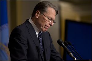National Rifle Association executive vice president Wayne LaPierre pauses as he makes a statement during a news conference in response to the Connecticut school shooting, on Friday, in Washington.