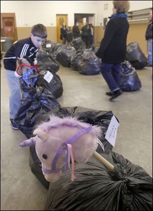 Volunteer Scott Upton, 12, helps with the bags of toys during the collection drive.