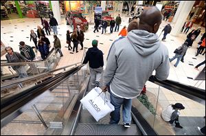 Holiday shoppers at the Twelve Oaks Mall in Novi, Mich., take advantage of more hours to shop and more sale items over the weekend as Christmas approaches.