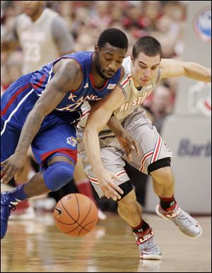 Ohio State's Aaron Craft, right scrambles for a steal against Kansas' Elijah Johnson. The Jayhawks shot 51 percent from the floor, while the Buckeyes made just 31 percent.