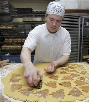 Baker Stephen Domanowski makes Christmas cookies at Wixey Bakery.