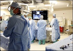 The surgical team at  ProMedica Toledo Hospital perform a minimally invasive procedure. Using a highly specialized robotic and computer-integrated surgical system known as da Vinci, gynecologists now can perform surgeries that are less invasive and offer a number of advantages to patients.