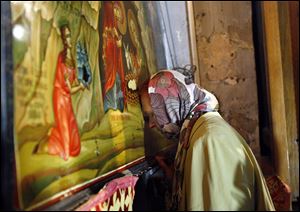 A Catholic pilgrim prays at the Church of Nativity, traditionally believed by Christians to be the birthplace of Jesus Christ, in the West Bank town of Bethlehem, today.