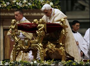 Pope Benedict XVI kneels today as he celebrates the Christmas Eve Mass in St. Peter's Basilica at the Vatican.