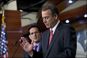 Speaker of the House John Boehner, joined by House Majority Leader Eric Cantor, R-Va., left, speaks to reporters about the fiscal cliff negotiations at the Capitol Friday.
