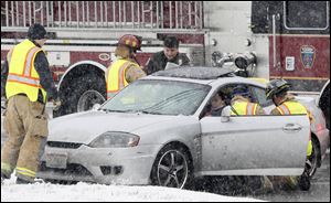 Sylvania Township crews assist a crash victim at West Central Avenue and Percentum Road.