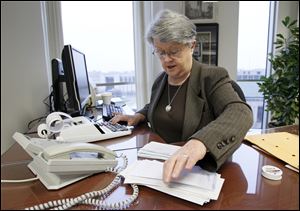 Lucas County Recorder Jeanine Perry says she attends to the smallest duties of the recorder's job, including making a daily deposit with the county auditor and treasurer of the day's receipts.