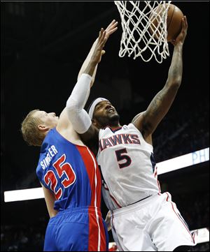 Atlanta Hawks small forward Josh Smith goes up for a basket as Detroit Pistons small forward Kyle Singler defends tonight in Atlanta.