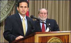 Hawaii Lt. Gov. Brian Schatz speaks the state Capitol in Honolulu today after Gov. Neil Abercrombie, right, announced he was appointing Schatz to fill the seat vacated by the late U.S. Sen. Daniel Inouye.