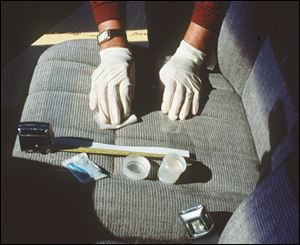 A researcher checks the seat of a car belonging to a worker at an Alabama machine shop. A study concluded that workers at the shop were contaminating their cars with beryllium dust.