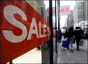 Price cuts such as those being advertised outside an H&M in New York, are likely to be deepened as retailers try to salvage the holiday season. 