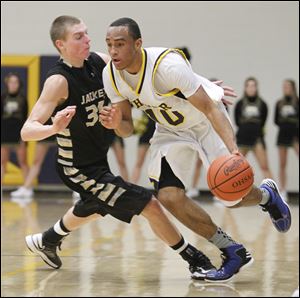 Whitmer's Ricardo Smith, who had 15 points, gets past Perrysburg's Shane Edwards in Thursday night's game.