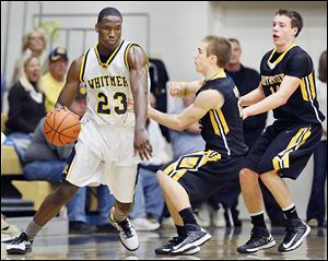 From left, Whitmer’s Nigel Hayes gets by Northview’s  Mark Bernsdorff and Connor Hartnett. Hayes had 14 points and 20 rebounds.