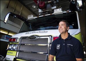 Scottsdale Firefighter Mark DeBruyckere poses at a fire station Dec. 23, in Scottsdale, Ariz. DeBruyckere is credited with helping to thwart a bank robber who tried to carjack motorists after robbing a bank in Scottsdale.