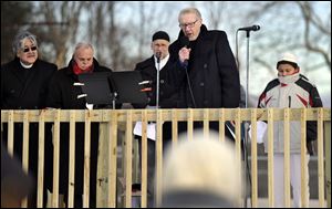 The Rev. Leo McIlrath offers a prayer during an interfaith prayer vigil to remember the victims of the Sandy Hook elementary school shootings Friday.