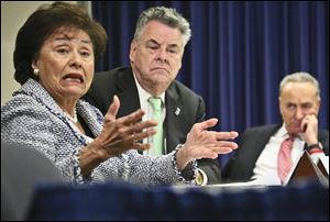 Congressman Peter King, center, and Senator Chuck Schumer, right, listens as Congresswoman Nita Lowey speaks during a news conference earlier this month.