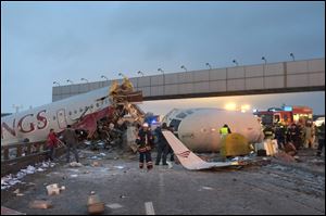 Rescuers work at the site where a plane careered off the runwaw at Vnukovo Airport in Moscow.