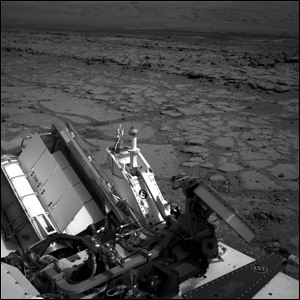 The Mars rover Curiosity at a pit stop, a shallow depression called 