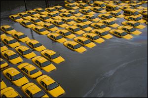 A parking lot full of yellow cabs is flooded as a result of Superstorm Sandy in Hoboken, N.J. 