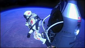 Felix Baumgartner of Austria pumps his fist to the crowd after successfully sky-diving from a capsule at an altitude of more than 24 miles. Mr. Baumgartner shattered the sound barrier while making the highest jump ever. He landed safely in the New Mexico desert. 