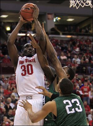 Ohio State's Evan Ravenel, left, is fouled by Chicago State's Markus Starks, center, as Aaron Williams (23) defends today in Columbus.