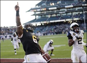 Arizona State running back Cameron Marshall celebrates his 33-yard touchdown run near Navy cornerback Parrish Gaines.