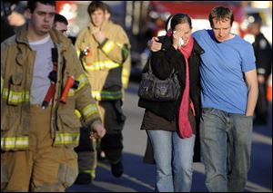 Robert and Alissa Parker leave a firehouse staging area after the shooting at Sandy Hook Elementary in Newtown, Conn., where a gunman killed 26 children and adults, including the Parkers' daughter Emilie, 6.