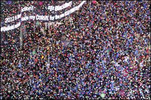 Confetti flies over New York's Times Square as the clock strikes midnight during the New Year's Eve celebration as seen from the balcony of the Marriott Marquis hotel.