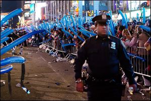 A police officer walks through a frozen zone in New York City’s Times Square as revelers wave balloons in anticipation of midnight last New Year's Eve.