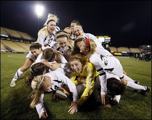 Perrysburg celebrates defeating Mason 1-0 at Crew Stadium in Columbus to capture the Division I girls soccer state championship and complete a 23-0-0 season.