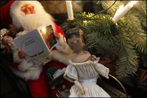 A small wooden doll and a Santa Claus are among the toys on display  at the Wolcott House Museum in Maumee. 