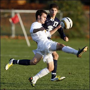 Daniel Blackmar moves the ball against Hayden Neese of St. John's in a Division I boys soccer district semifinal. Blackmar, who had 27 goals this season, helped the Cougars reach the state final.