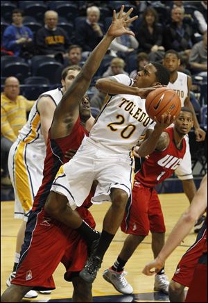 Toledo's Julius Brown is defended by Illinois-Chicago's Josh Crittle as he looks to take a shot Saturday.