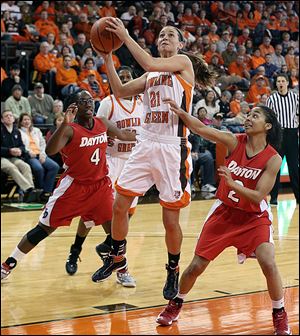 Bowling Green's Chrissy Steffen goes the basket against Dayton's Olivia Applewhite left,, and Amber Dean at the Stroh Center. Steffen had 16 points to go past 1,000 for her career.
