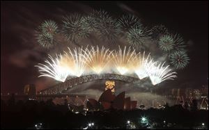 Fireworks explode in the sky above Sydney Harbour during the New Years Eve celebrations in Sydney, Australia.