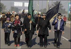 Shiite pilgrims march to Karbala for the Arbaeen celebration in Baghdad, Iraq today. Each year, hundreds of thousands converge on the southern city of Karbala to mark the end of the forty day mourning period following the anniversary of the 7th century death of the Prophet Muhammad's grandson, Imam Hussein.