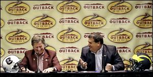 South Carolina head coach Steve Spurrier, left, shares a laugh with Michigan head coach Brady Hoke during a joint news conference Monday in Tampa, Fla.