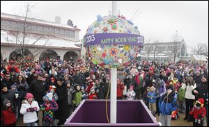 Spectators observe the rising of the New Year's ball during festivi-ties  at the Toledo Zoo that included games and arts and crafts. 