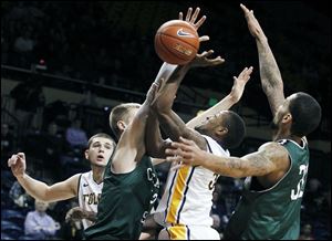 Chicago State's Matt Ross blocks a shot by UT's Rian Pearson, who had 14 points. The Rockets fell to 4-7.