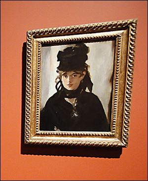 Keon Pearson, center, of Toledo enjoys the last day of the popular Manet exhibit at the Toledo Museum Art in Toledo.