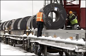 Steel coils are loaded onto rail cars at the Port of Cleveland. About 160 rail cars — which can carry more cargo and take it farther than trucks can — will be loaded with three shiploads of steel in the coming weeks.