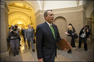 House Speaker John Boehner walks to his office on Capitol Hill in Washington, today, as legislation to negate a fiscal cliff of across-the-board tax increases and sweeping spending cuts moves to the GOP-dominated House following a bipartisan, middle-of-the-night approval in the Senate. 